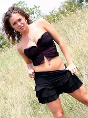 Jade outdoors in a field in a skirt on a windy day!